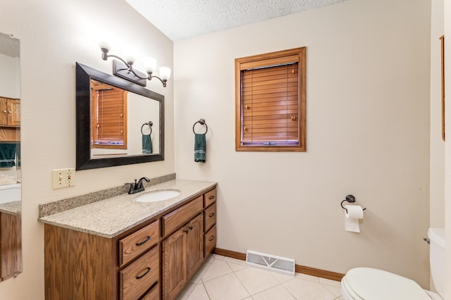 39123 Kc Dr, Homer Twp, MN 55987 - bathroom featuring vanity, tile patterned flooring, and a textured ceiling