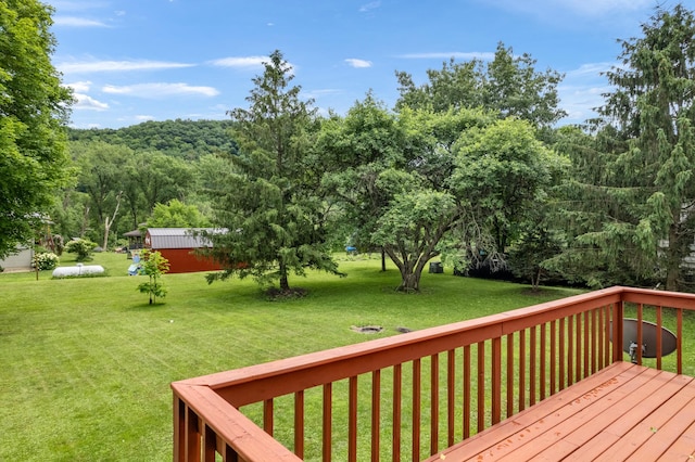 39123 Kc Dr, Homer Twp, MN 55987 - wooden deck featuring a lawn and a wooded view