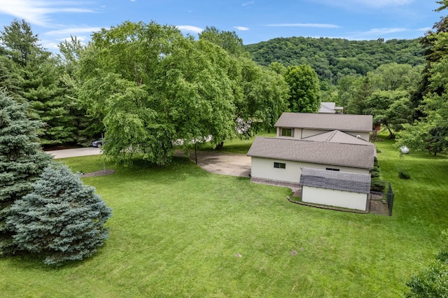39123 Kc Dr, Homer Twp, MN 55987 - view of green lawn featuring a storage shed and a forest view
