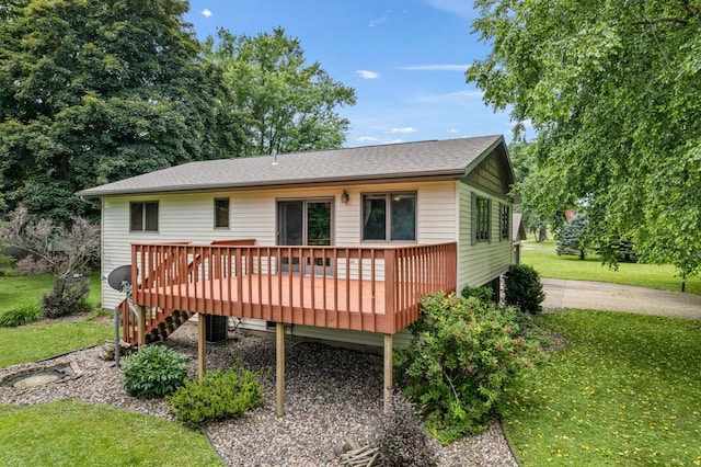 39123 Kc Dr, Homer Twp, MN 55987 - rear view of house featuring a lawn and a wooden deck