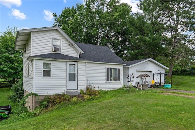 1938 190th St, Stanton Twp, WI 54017 - view of front of house featuring a front yard, a garage, roof with shingles, and an outbuilding