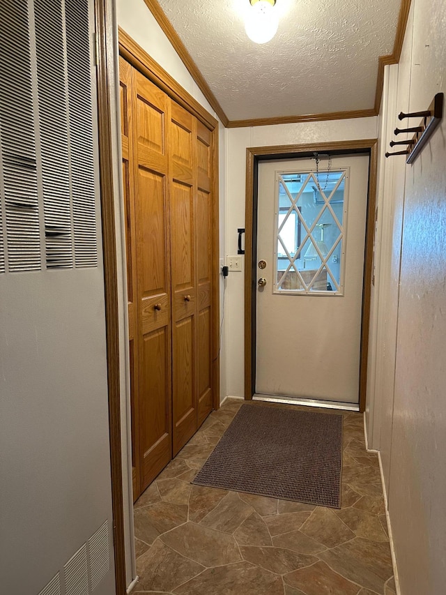 217 4th Ave SE, Pipestone, MN 56164 - doorway to outside with a heating unit, ornamental molding, a textured ceiling, and dark stone finish floors