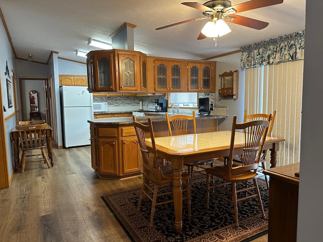 217 4th Ave SE, Pipestone, MN 56164 - dining space featuring ornamental molding, wood finished floors, a ceiling fan, and a textured ceiling