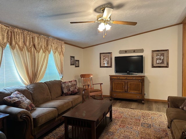 217 4th Ave SE, Pipestone, MN 56164 - living area with lofted ceiling, a ceiling fan, wood finished floors, a textured ceiling, and ornamental molding