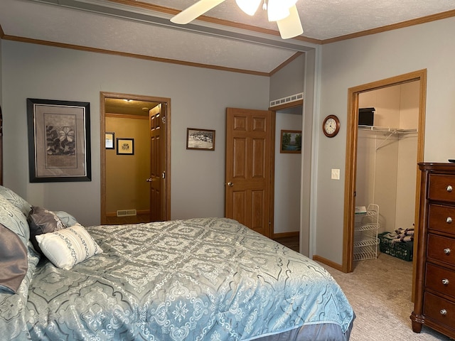 217 4th Ave SE, Pipestone, MN 56164 - bedroom with light colored carpet, a closet, crown molding, ceiling fan, and a walk in closet