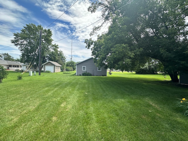 217 4th Ave SE, Pipestone, MN 56164 - view of grassy yard featuring a garage and an outdoor structure