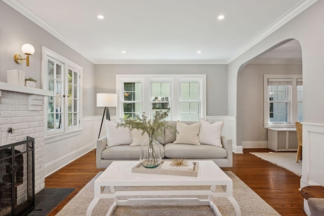 4510 Arden Ave, Edina, MN 55424 - living area featuring arched walkways, a wainscoted wall, dark wood finished floors, recessed lighting, and a fireplace