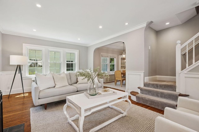 4510 Arden Ave, Edina, MN 55424 - living area featuring wood finished floors, a wainscoted wall, stairs, arched walkways, and crown molding