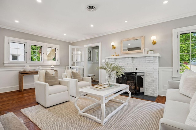 4510 Arden Ave, Edina, MN 55424 - living room with a fireplace, ornamental molding, wood finished floors, recessed lighting, and a wainscoted wall