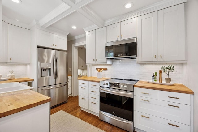 4510 Arden Ave, Edina, MN 55424 - kitchen with butcher block countertops, appliances with stainless steel finishes, ornamental molding, tasteful backsplash, and dark wood-type flooring