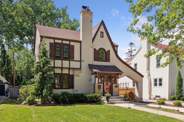 4510 Arden Ave, Edina, MN 55424 - tudor home with stucco siding, a shingled roof, and a chimney