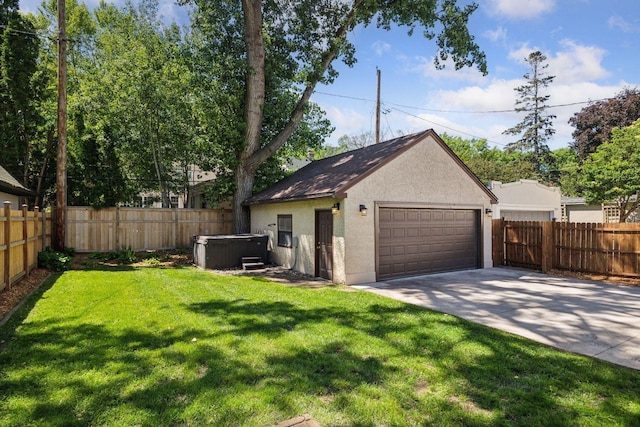 4510 Arden Ave, Edina, MN 55424 - back of house featuring a hot tub, stucco siding, a garage, and a fenced backyard