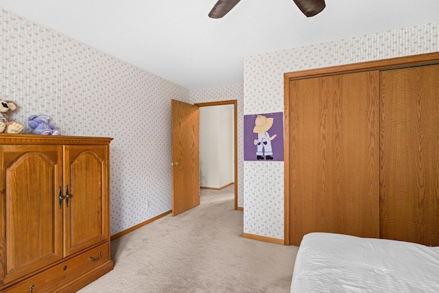 9614 Hayes Rd, Mountain Iron, MN 55768 - bedroom featuring light colored carpet, wallpapered walls, a ceiling fan, and a closet