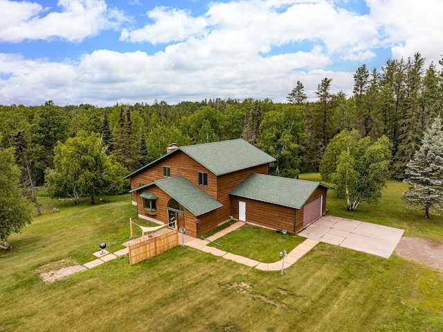 9614 Hayes Rd, Mountain Iron, MN 55768 - view of front facade with a shingled roof, a view of trees, a garage, and driveway