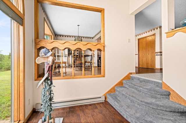 9614 Hayes Rd, Mountain Iron, MN 55768 - stairs with wood finished floors, a baseboard radiator, a chandelier, and a towering ceiling