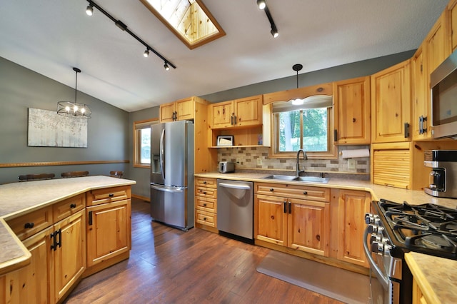 30467 Lakeview Dr, Breezy Point, MN 56472 - kitchen featuring appliances with stainless steel finishes, rail lighting, light countertops, decorative backsplash, and vaulted ceiling