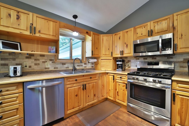 30467 Lakeview Dr, Breezy Point, MN 56472 - kitchen featuring appliances with stainless steel finishes, lofted ceiling, dark wood-type flooring, tasteful backsplash, and light countertops