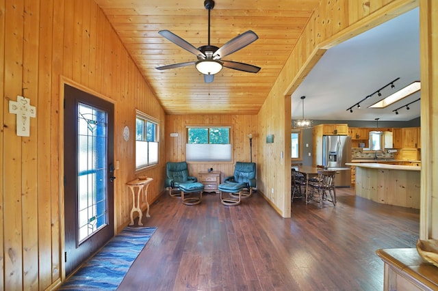 30467 Lakeview Dr, Breezy Point, MN 56472 - living area featuring dark wood-type flooring, wooden walls, a ceiling fan, and rail lighting
