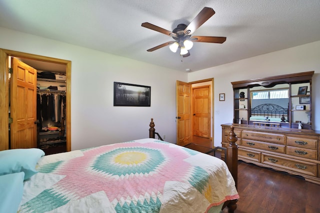 30467 Lakeview Dr, Breezy Point, MN 56472 - bedroom featuring dark wood finished floors, a closet, ceiling fan, a walk in closet, and a textured ceiling