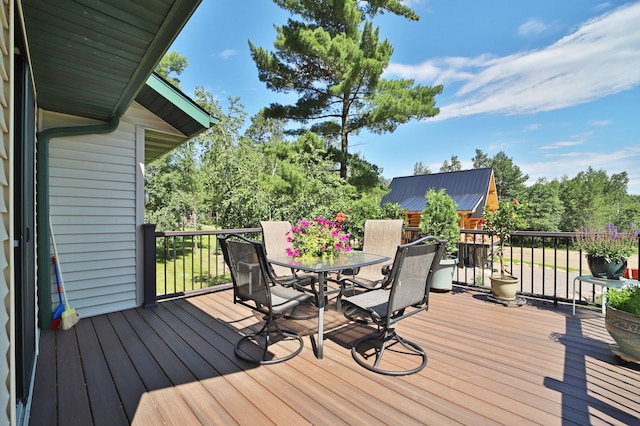 30467 Lakeview Dr, Breezy Point, MN 56472 - wooden deck featuring outdoor dining area and view of scattered trees