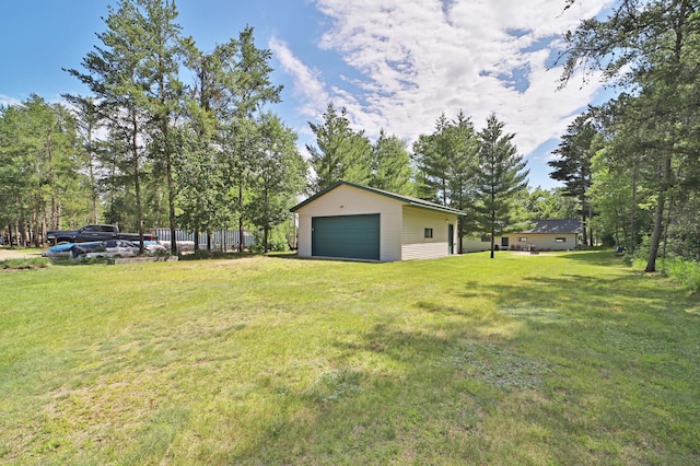 30467 Lakeview Dr, Breezy Point, MN 56472 - view of grassy yard featuring a garage, an outdoor structure, and view of wooded area