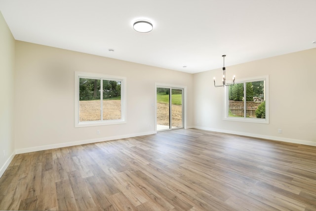 2529 Elmcroft Dr SW, Rochester, MN 55902 - spare room with a chandelier and wood finished floors