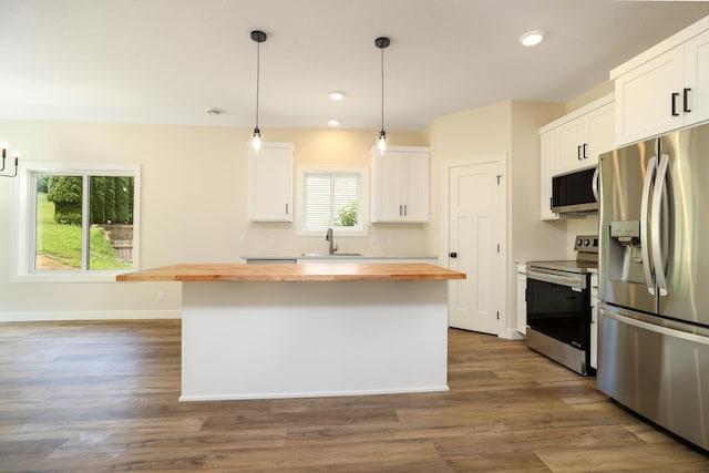 2529 Elmcroft Dr SW, Rochester, MN 55902 - kitchen with wood counters, appliances with stainless steel finishes, a kitchen island, white cabinetry, and pendant lighting