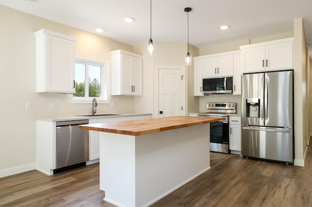 2529 Elmcroft Dr SW, Rochester, MN 55902 - kitchen with stainless steel appliances, wood counters, white cabinetry, dark wood-style flooring, and a kitchen island