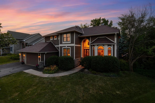 12346 Harvard Ave, Eden Prairie, MN 55347 - view of front of home with concrete driveway, a yard, an attached garage, and stone siding