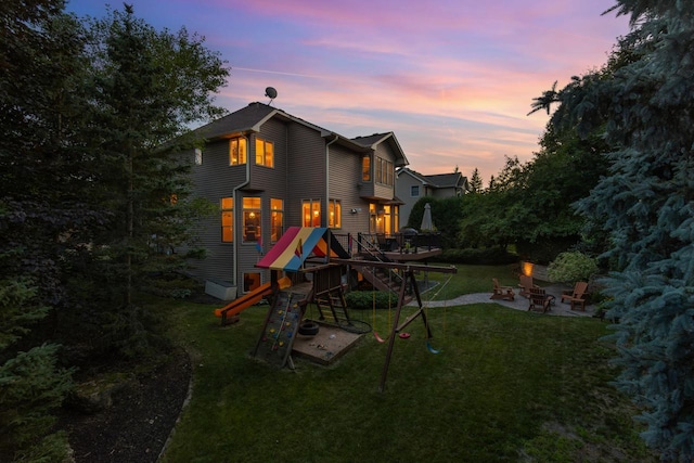 12346 Harvard Ave, Eden Prairie, MN 55347 - view of jungle gym featuring a fire pit, a lawn, and a patio area
