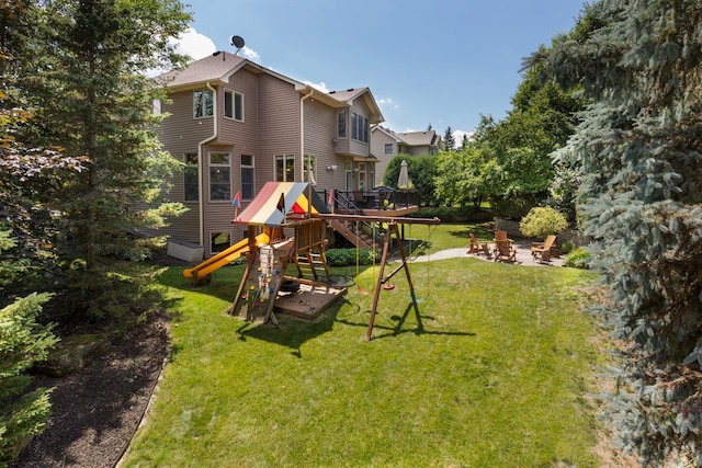 12346 Harvard Ave, Eden Prairie, MN 55347 - back of house with a playground, an outdoor fire pit, and a lawn