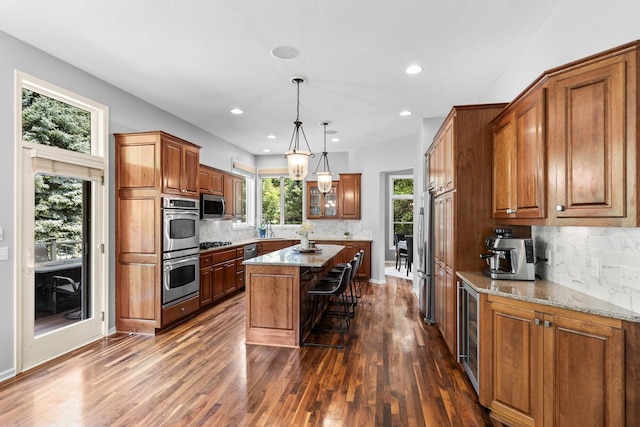 12346 Harvard Ave, Eden Prairie, MN 55347 - kitchen with stainless steel appliances, dark wood-type flooring, backsplash, a center island, and recessed lighting