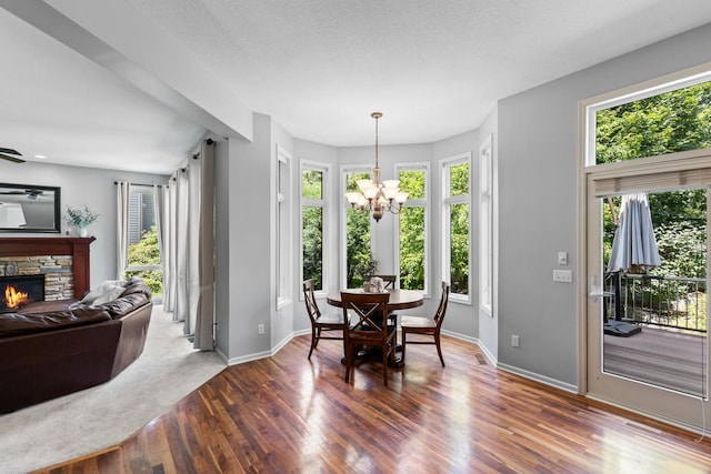12346 Harvard Ave, Eden Prairie, MN 55347 - dining space with wood finished floors, a chandelier, and a fireplace