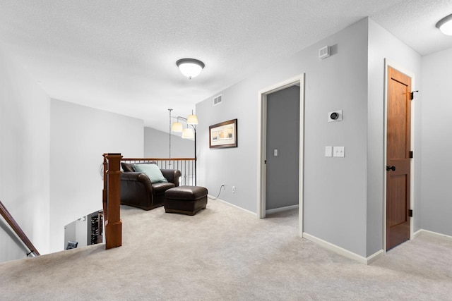 12346 Harvard Ave, Eden Prairie, MN 55347 - sitting room featuring an upstairs landing, carpet floors, and a textured ceiling