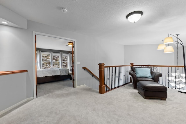 12346 Harvard Ave, Eden Prairie, MN 55347 - sitting room featuring an upstairs landing, carpet flooring, a textured ceiling, and ceiling fan