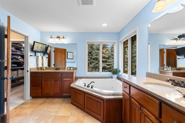 12346 Harvard Ave, Eden Prairie, MN 55347 - full bathroom featuring two vanities and a whirlpool tub