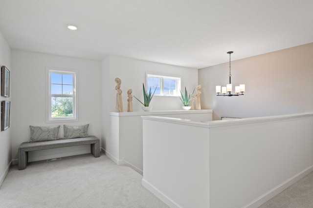 2548 Aspen Ct, Shakopee, MN 55379 - hallway with a chandelier, healthy amount of natural light, and light carpet