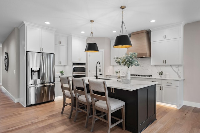 7617 Ocean Ave NE, Otsego, MN 55330 - kitchen featuring stainless steel appliances, wall chimney range hood, backsplash, light wood-type flooring, and recessed lighting
