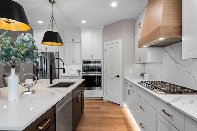 7617 Ocean Ave NE, Otsego, MN 55330 - kitchen with custom range hood, appliances with stainless steel finishes, decorative backsplash, decorative light fixtures, and recessed lighting