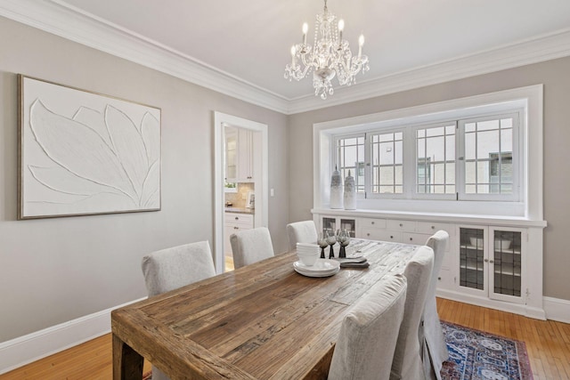 1770 Humboldt Ave S Unit 1, Minneapolis, MN 55403 - dining area featuring a chandelier, crown molding, and light wood-style flooring