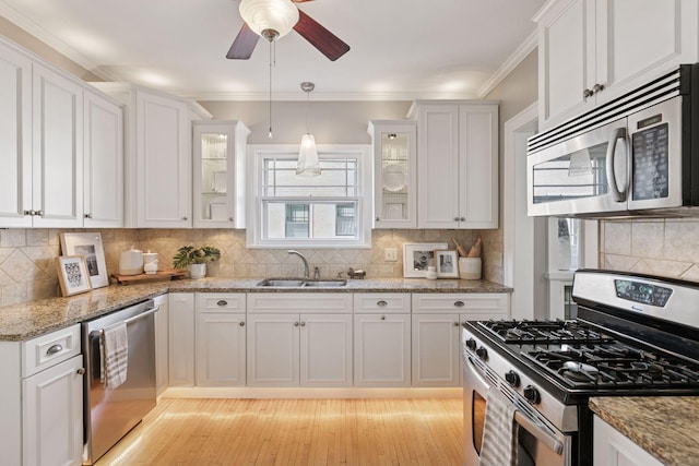 1770 Humboldt Ave S Unit 1, Minneapolis, MN 55403 - kitchen with appliances with stainless steel finishes, white cabinetry, decorative backsplash, ceiling fan, and glass insert cabinets