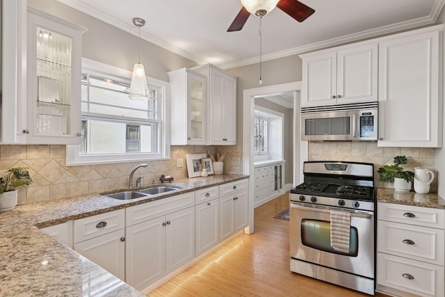 1770 Humboldt Ave S Unit 1, Minneapolis, MN 55403 - kitchen with appliances with stainless steel finishes, white cabinetry, glass insert cabinets, light wood finished floors, and crown molding