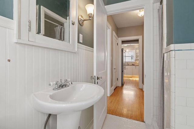 1770 Humboldt Ave S Unit 1, Minneapolis, MN 55403 - full bathroom featuring wainscoting and a shower with shower curtain