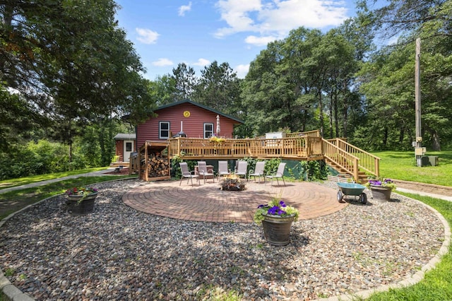 4745 Patterson Trl, Brainerd, MN 56401 - rear view of property featuring a deck, a patio area, stairs, an outdoor fire pit, and a lawn
