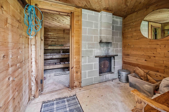 4745 Patterson Trl, Brainerd, MN 56401 - unfurnished living room featuring wooden walls, wood ceiling, a fireplace, and concrete floors