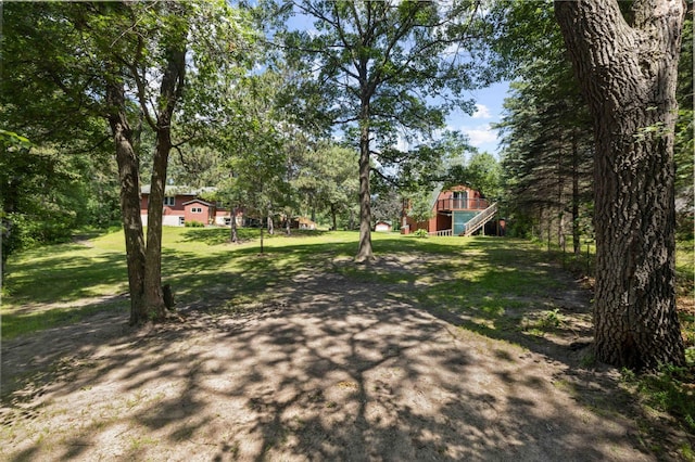 4745 Patterson Trl, Brainerd, MN 56401 - view of grassy yard with view of wooded area and stairs