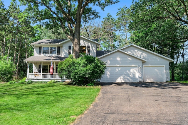 621 Twelve Oaks Ln, Hudson, WI 54016 - view of front of house with driveway, a front lawn, a porch, and a garage