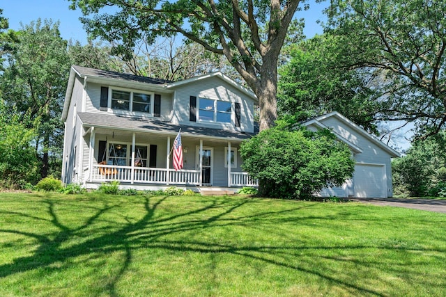 621 Twelve Oaks Ln, Hudson, WI 54016 - traditional-style home featuring asphalt driveway, a front lawn, a porch, and a garage