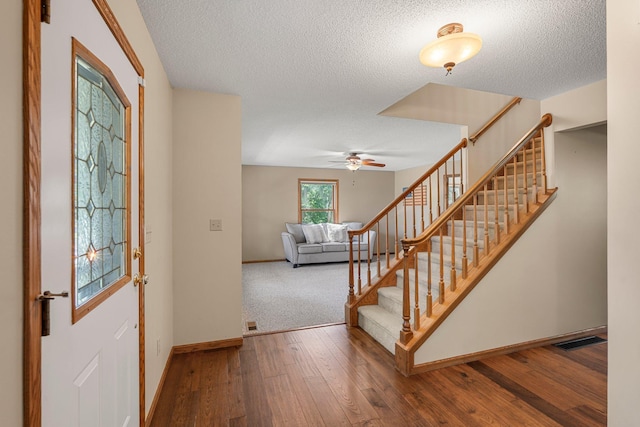621 Twelve Oaks Ln, Hudson, WI 54016 - foyer entrance featuring a textured ceiling, stairs, ceiling fan, and wood-type flooring