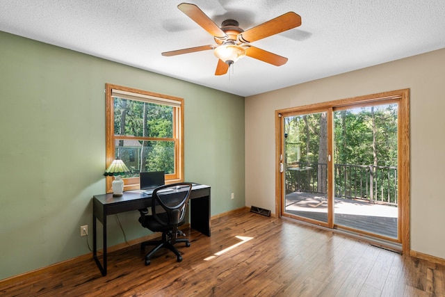 621 Twelve Oaks Ln, Hudson, WI 54016 - office featuring wood-type flooring, healthy amount of natural light, a ceiling fan, and a textured ceiling